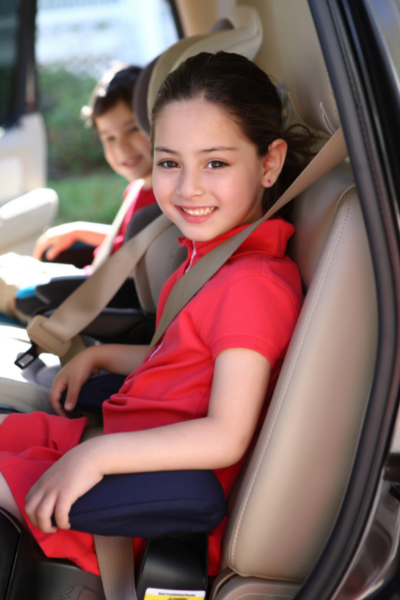 A kid smiling in the car